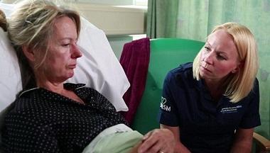 Nurse talking to a patient in bed