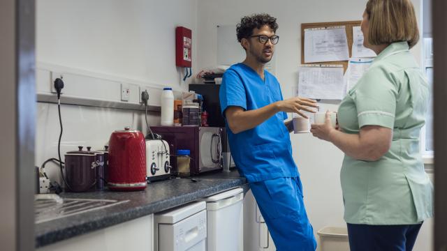 Colleagues talking in a kitchen